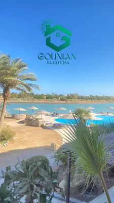 a view of a beach with palm trees and the ocean at El Gouna west golf Y12 in Hurghada