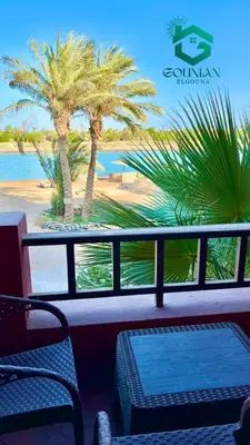 a balcony with a table and chairs and a palm tree at El Gouna west golf Y12 in Hurghada