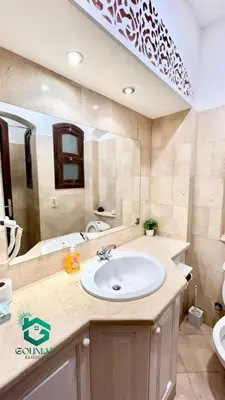 a bathroom with a white sink and a tub at El Gouna west golf Y12 in Hurghada