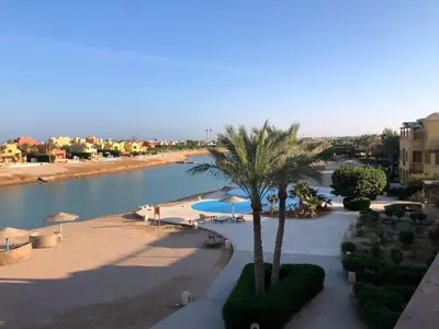 a view of a beach with palm trees and umbrellas at El Gouna west golf Y12 in Hurghada