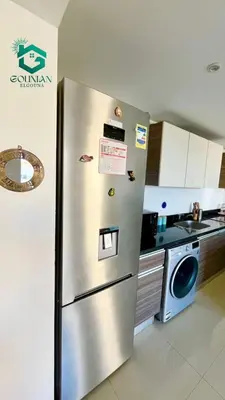 a stainless steel refrigerator in a kitchen with a dishwasher at ElGouna G-cribs One Bedroom in Hurghada