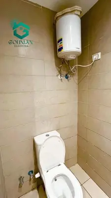 a bathroom with a toilet and a water tank at ElGouna G-cribs One Bedroom in Hurghada