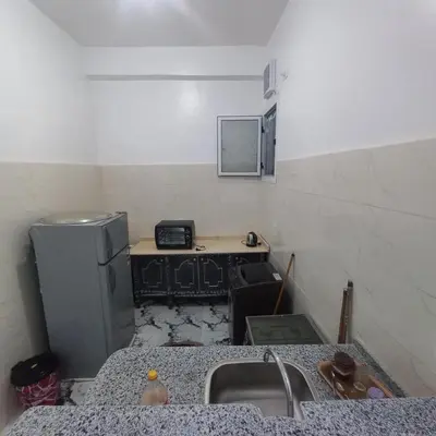 a kitchen with a sink and a refrigerator at Nora House in Luxor