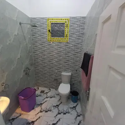 a bathroom with a toilet and a smashed floor at Nora House in Luxor