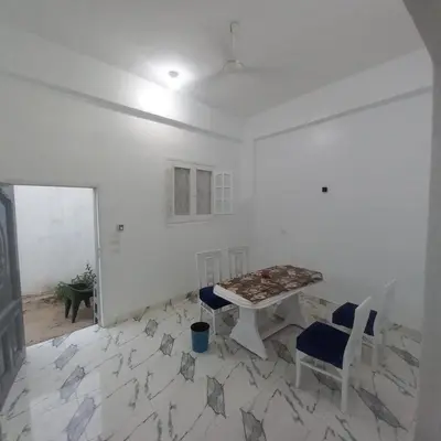 a white room with a table and two chairs at Nora House in Luxor