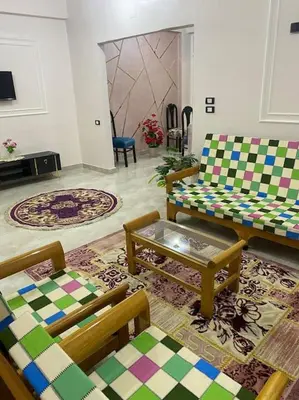 a living room with two couches and a table at Steven in Luxor