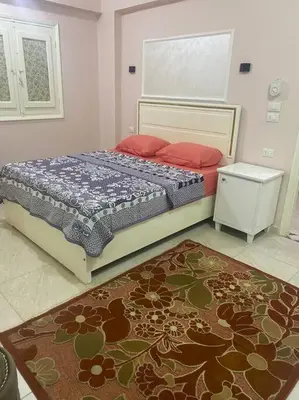 a bedroom with a bed and a rug at Just the two of us in Luxor