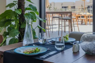 a table with plates of food and glasses on it at Aldiana Club Naga Bay in Hurghada