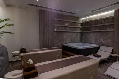 a spa room with a bath tub and a table at Aldiana Club Naga Bay in Hurghada