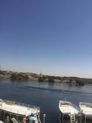 two boats are docked on a river at بيت ملكه house of malaka in Naj‘ al Maḩaţţah