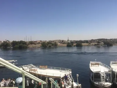 a group of people boarding a boat on a river at بيت ملكه house of malaka in Naj‘ al Maḩaţţah