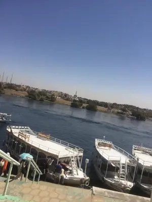 two boats docked at a dock on a river at بيت ملكه house of malaka in Naj‘ al Maḩaţţah