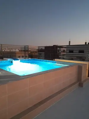 a large swimming pool with blue water in a building at Wadjet-inn in Hurghada