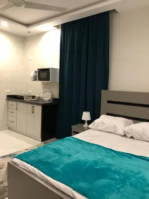 a bedroom with a bed with a blue blanket on it at Wadjet-inn in Hurghada
