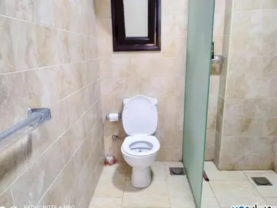 a bathroom with a toilet in a shower stall at Tertels beach resort F 1-7 in Hurghada