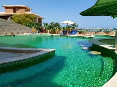 a swimming pool with turquoise water at Tertels beach resort F 1-7 in Hurghada