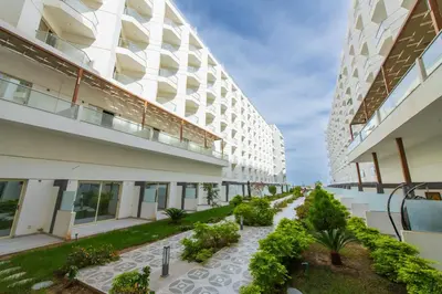 an apartment building with a walkway between two buildings at scandic resort 647 in Hurghada