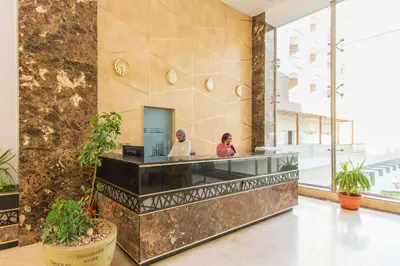 a lobby with two people sitting at a counter at scandic resort 647 in Hurghada