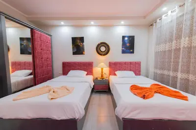 two beds in a room with red dividers at scandic resort 647 in Hurghada