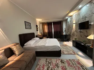 a hotel room with a bed and a couch at scandic resort 523 in Hurghada