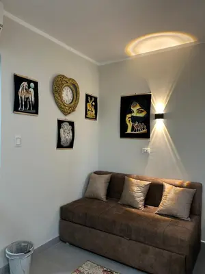 a living room with a couch and some pictures on the wall at scandic resort 523 in Hurghada
