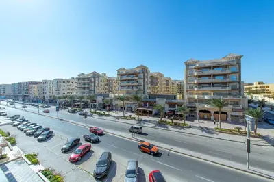 a city street with cars parked in a parking lot at scandic resort 523 in Hurghada