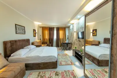 a hotel room with two beds and a mirror at scandic resort 523 in Hurghada