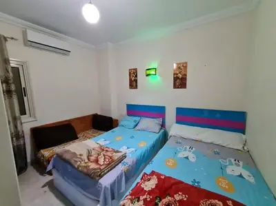 a bedroom with two twin beds in a room at Farida in Hurghada