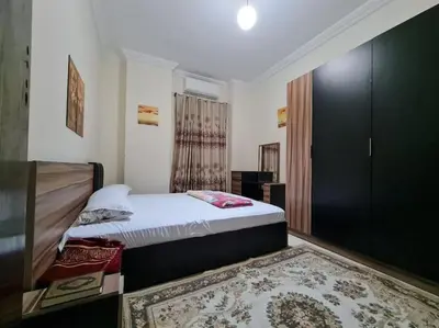 a small bedroom with a bed and a rug at Farida in Hurghada