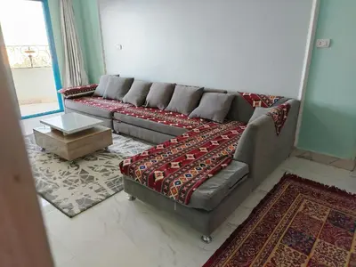 a living room with a couch and a table at Nubian Mood in Naj‘ al Maḩaţţah