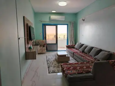 a living room with a couch and a table at Nubian Mood in Naj‘ al Maḩaţţah
