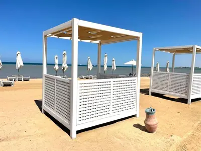 a group of umbrellas and chairs on a beach at SunShine Mangrove in Hurghada