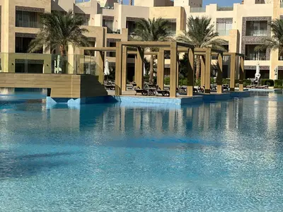 a swimming pool in front of a large building at SunShine Mangrove in Hurghada