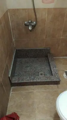 a bathroom with a shower with a tile floor at hurgada hapy room in Hurghada