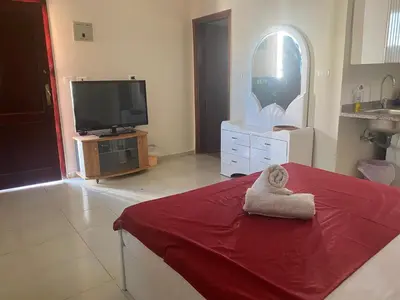 a living room with a tv and a towel at hurgada hapy room in Hurghada