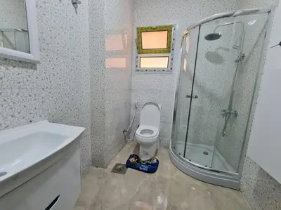 a bathroom with a shower and a toilet and a sink at Golden Home in Hurghada