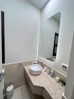 a bathroom with a sink and a mirror at Stylish 1BR Ground With Free Pool & Lagoon Access In Gouna in Hurghada