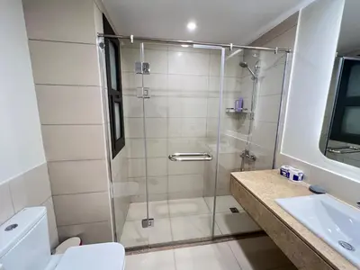 a bathroom with a shower and a toilet and a sink at Stylish 1BR Ground With Free Pool & Lagoon Access In Gouna in Hurghada