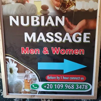 a sign for a nubian massage man and woman at Dream house in Luxor