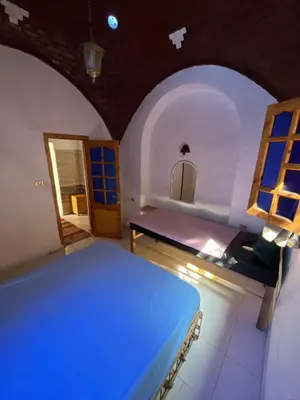 a room with a blue bed and a window at Dream house in Luxor