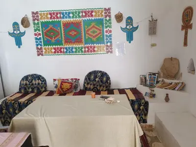a room with a table and two chairs and a rug at Dream house in Luxor