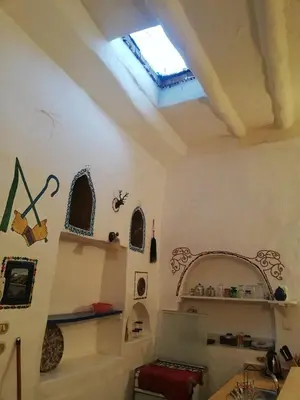 a room with a ceiling with a window and shelves at Dream house in Luxor