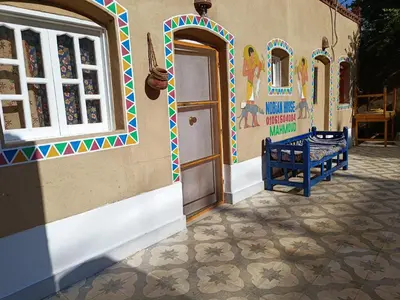 a building with a door and a bench next to it at Dream house in Luxor