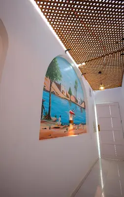a painting on a wall in a room with a door at JAREEDY Guest house in Shellal