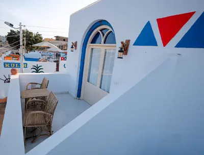 a balcony with a door and a table and chairs at JAREEDY Guest house in Shellal