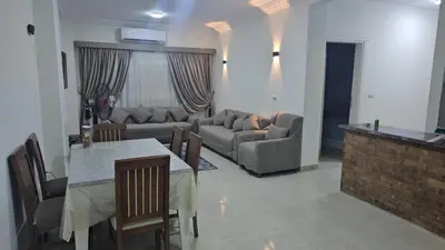 a living room with a couch and a table at Hurghada red ruby in Hurghada