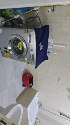 a washing machine in a bathroom with a toilet at Hurghada red ruby in Hurghada