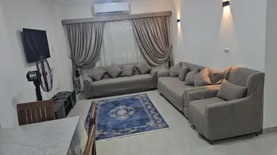 a living room with a couch and a table at Hurghada red ruby in Hurghada
