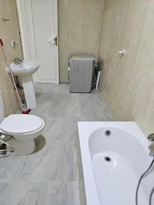 a bathroom with a tub and a toilet and a sink at Hurghada red ruby in Hurghada