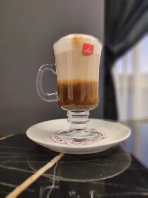 a cup of coffee on a plate on a table at Hotel apartment with a private beach in Hurghada